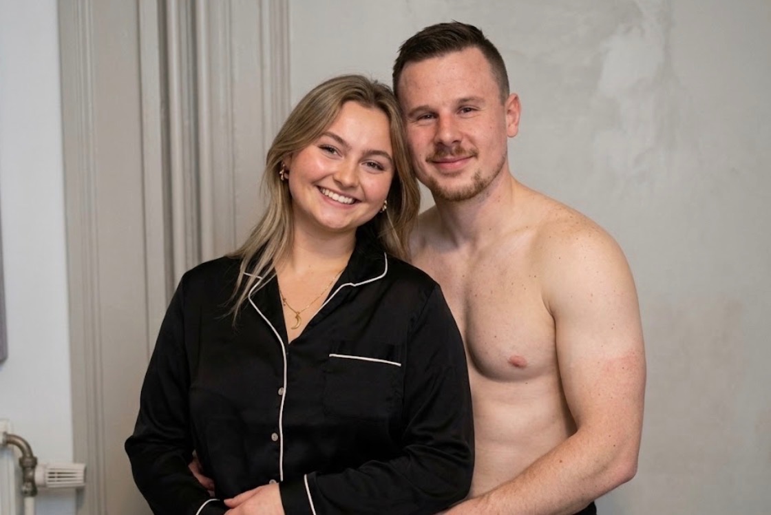 Shot 1 [0-3s]: The man unbuttons her satin pajama top, sliding it off her shoulders and down her arms to the floor, lea…