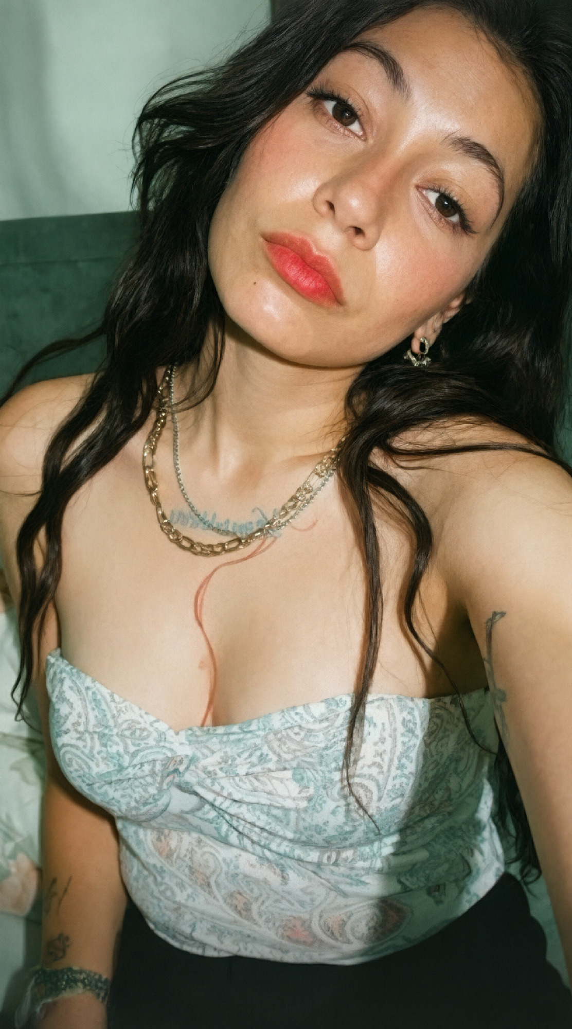 Once off, the light blue patterned strapless top stays on the floor where it lands for the rest of the shot, and her sk…